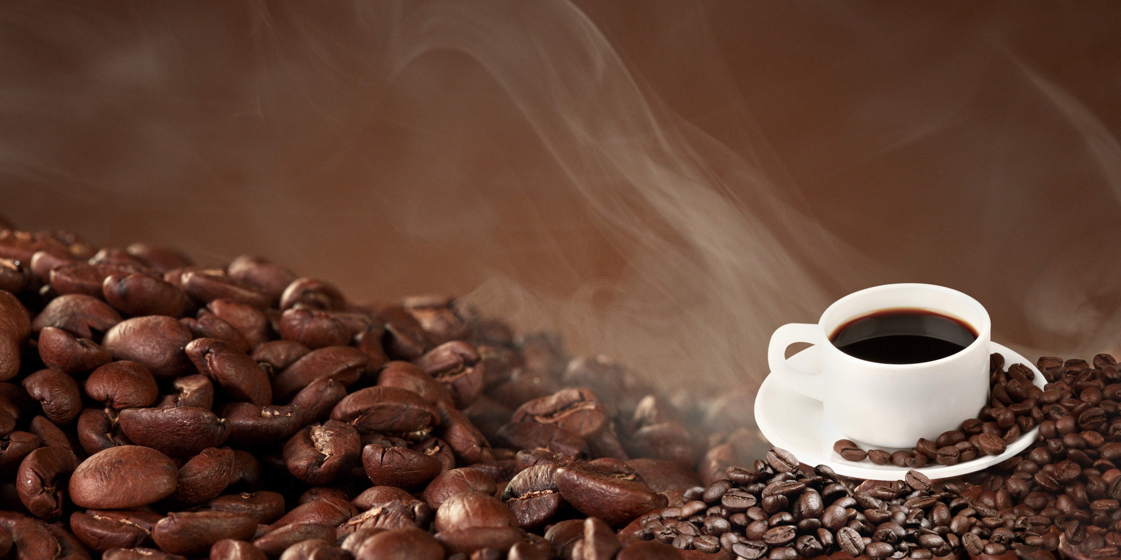 white coffee cup on coffee beans