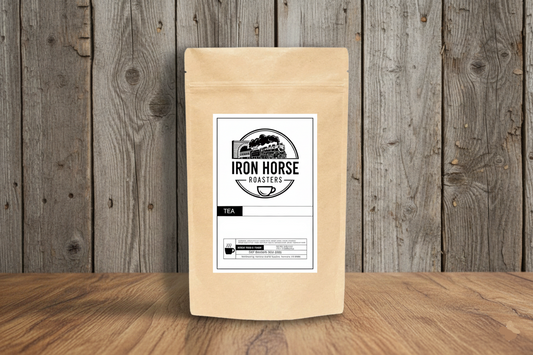 Tea package with 'Iron Horse Roasters' label on a wooden surface and background